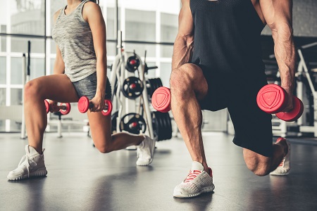 Two people 
				working out with a weight in each hand