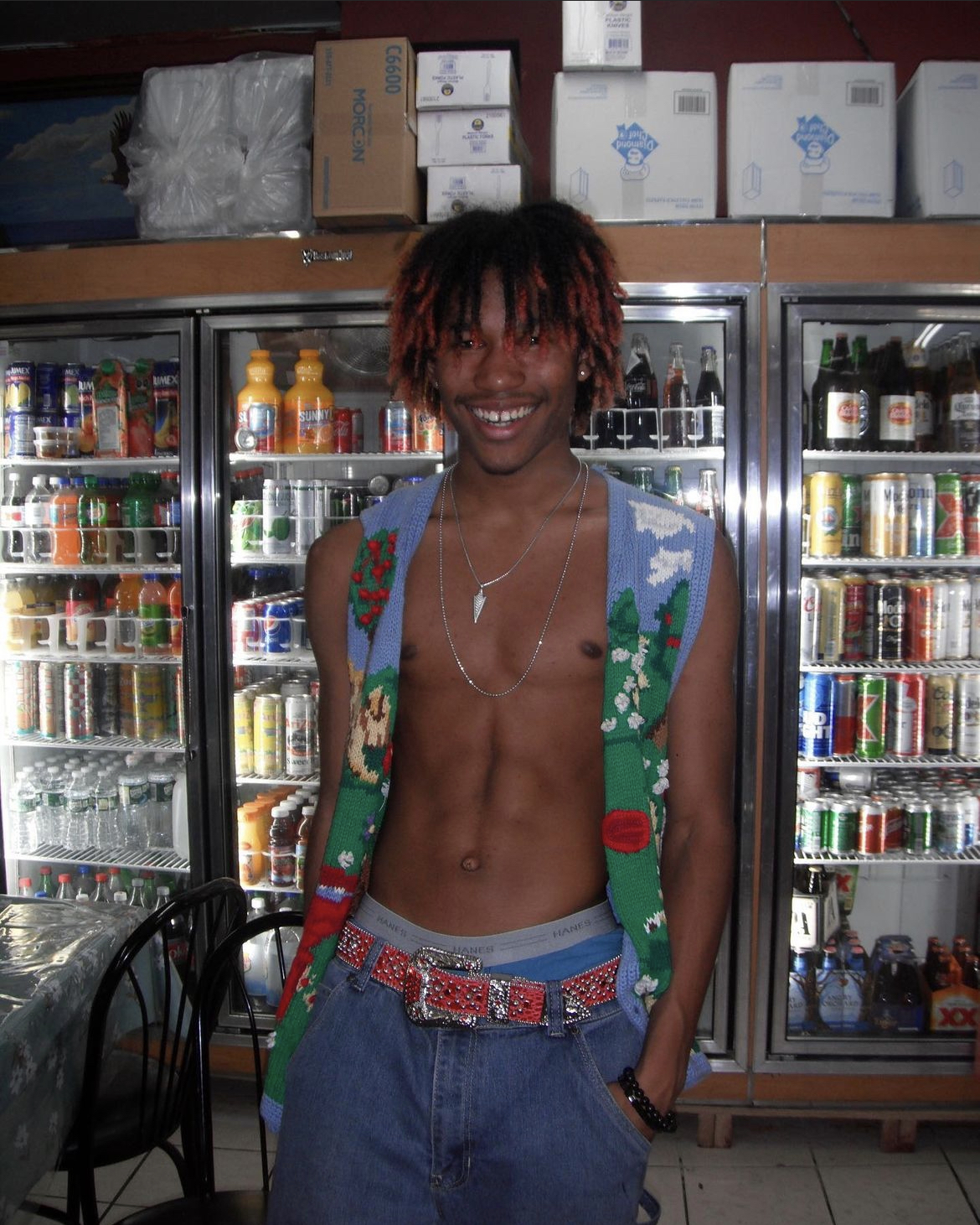 Josiah posing in front of a deli cooler