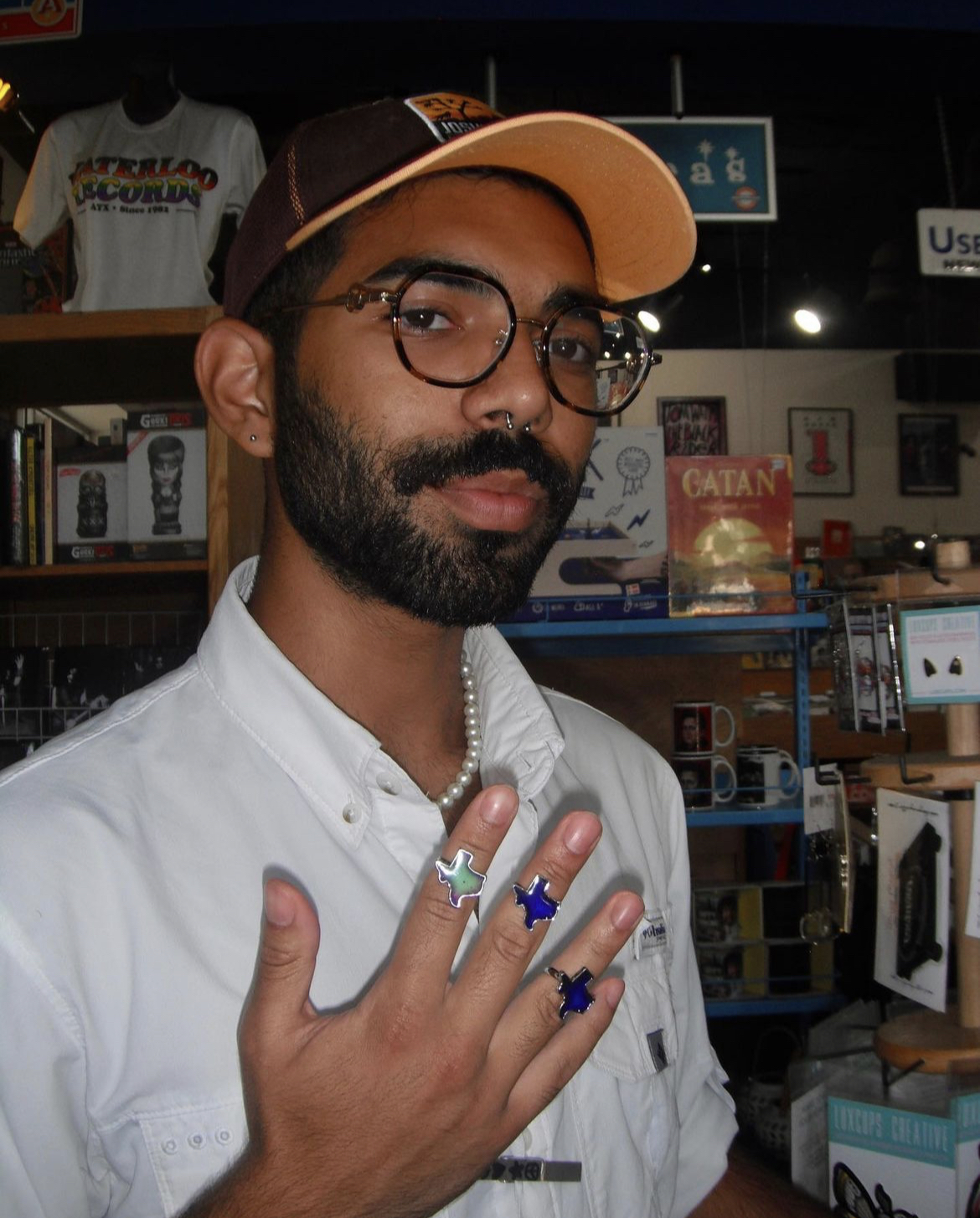 Ahmed posing with texas shaped rings on his fingers