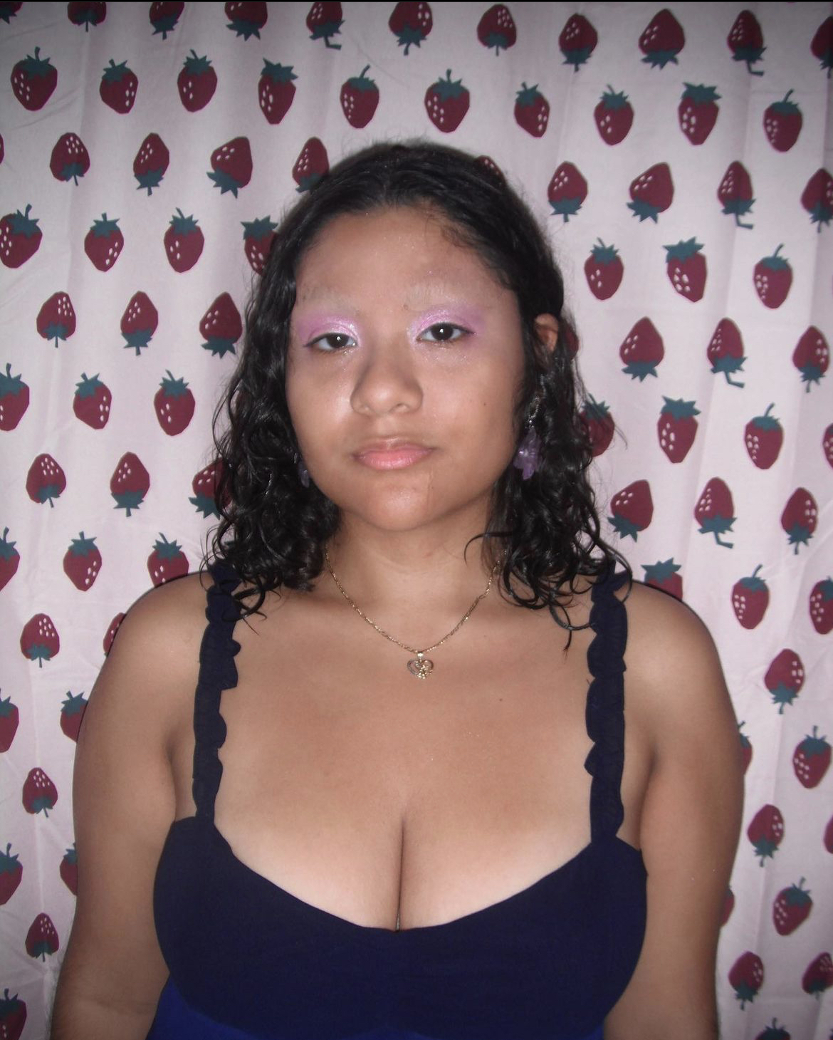 Anahy posing in front of a shower 
            curtain with makeup covering her eyebrows