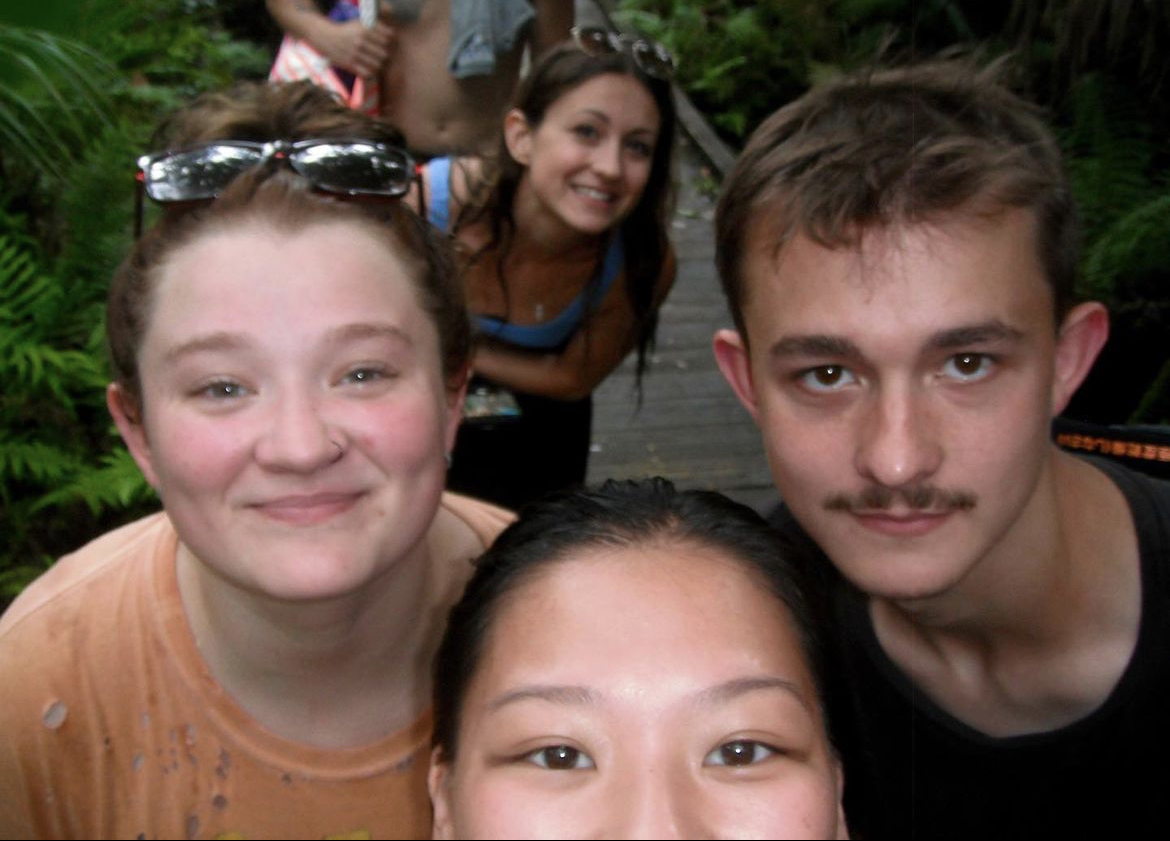 Emily, Maddy, and Robert with Nicole in the 
            background posing for a selfie