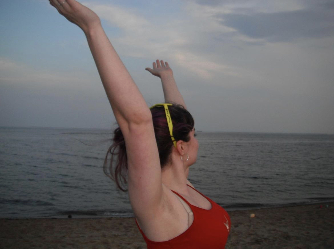 Mary with her hands thrown up on the beach