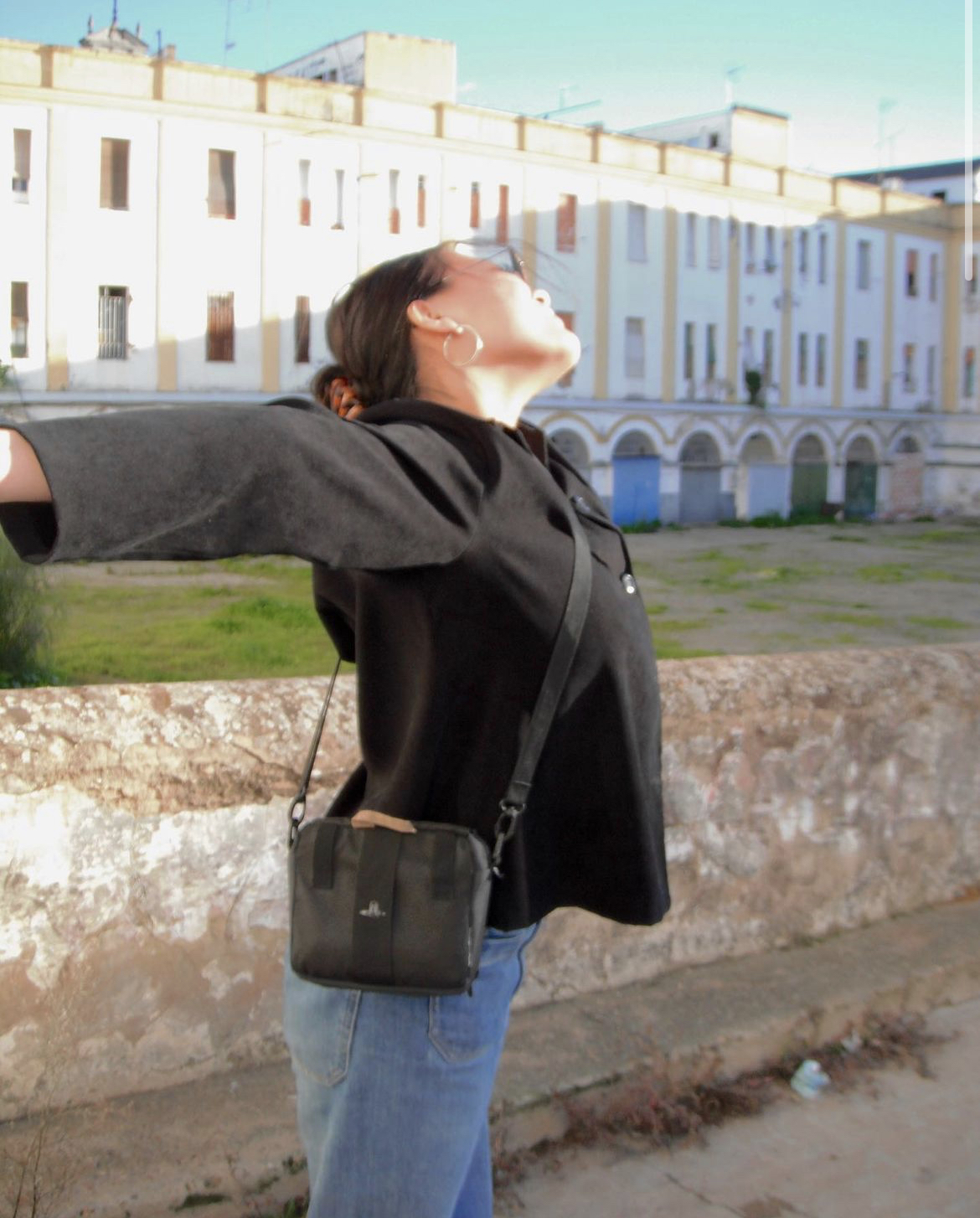 Girl with arms extended in the sun